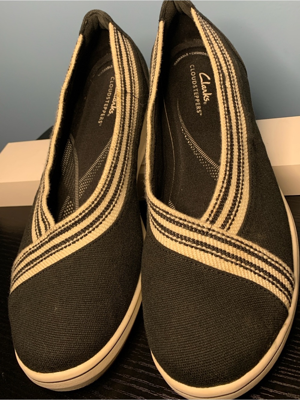Clarks Women’s Black Canvas Slip-Ons with Cream Stripe Trim
